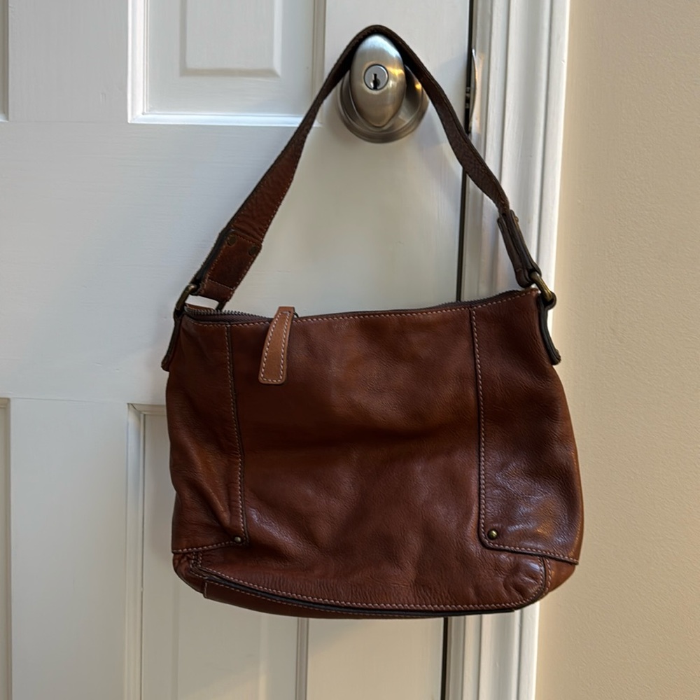 distressed brown shoulder bag.  Fits well on shoulder with or without a jacket.